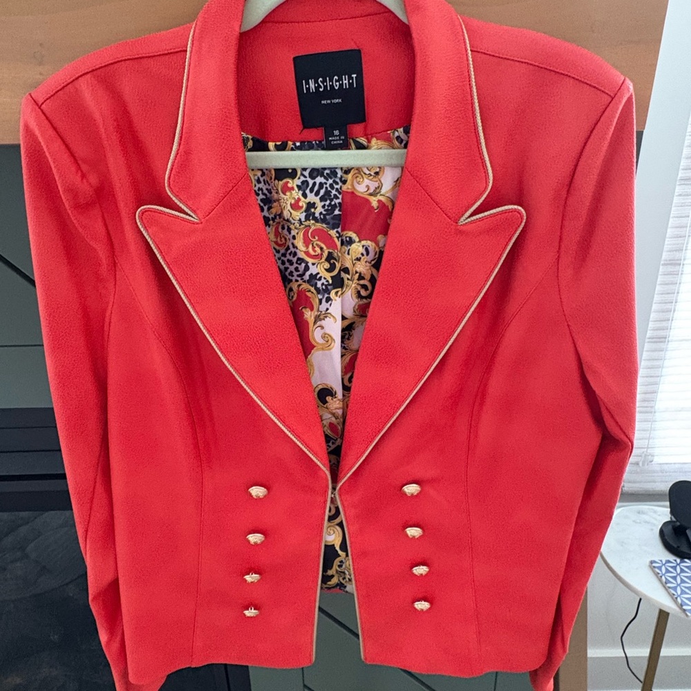 Insight Red Faux Leather short jacket with Notched Lapels and gold accents.